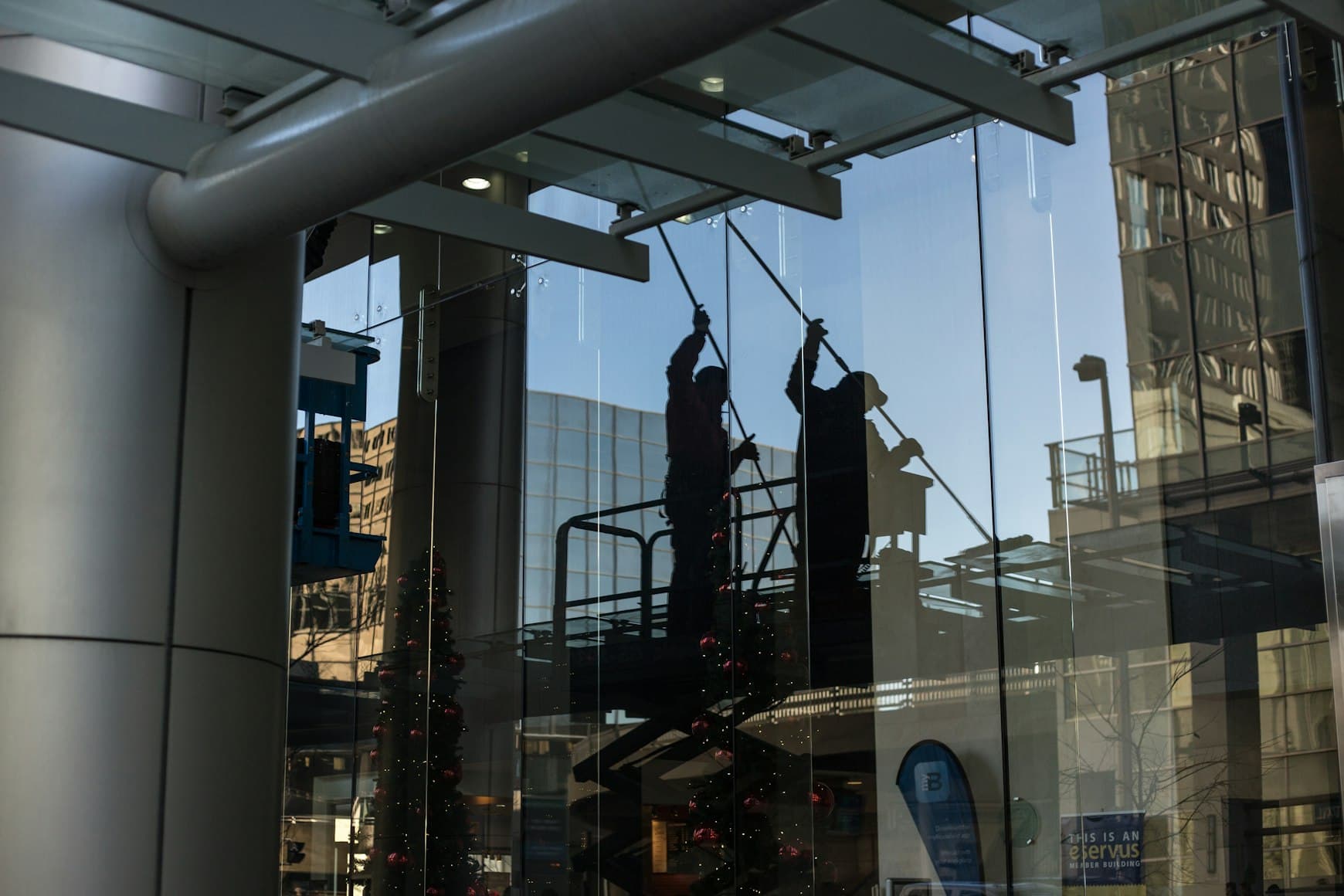 Professional window cleaning team at work on a glass building facade